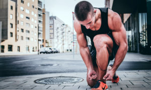 Man tying shoe laces in running gear